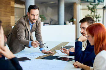 Business Team Engaged in Office Discussion Around Conference Table