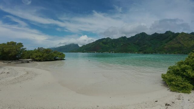 View Moorea Tahiti island from a white sand beach  