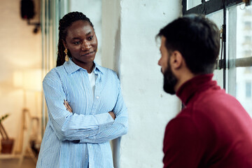 Two Colleagues Engaged in a Thoughtful Conversation in a Bright Office Space
