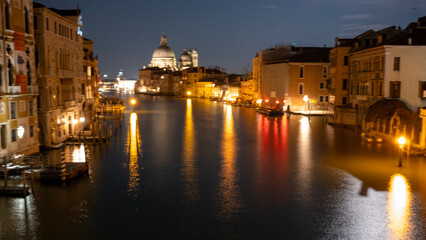 Fototapeta premium Night View of the Grand Canal with Reflections and Basilica di Santa Maria della Salute in Venice, Italy