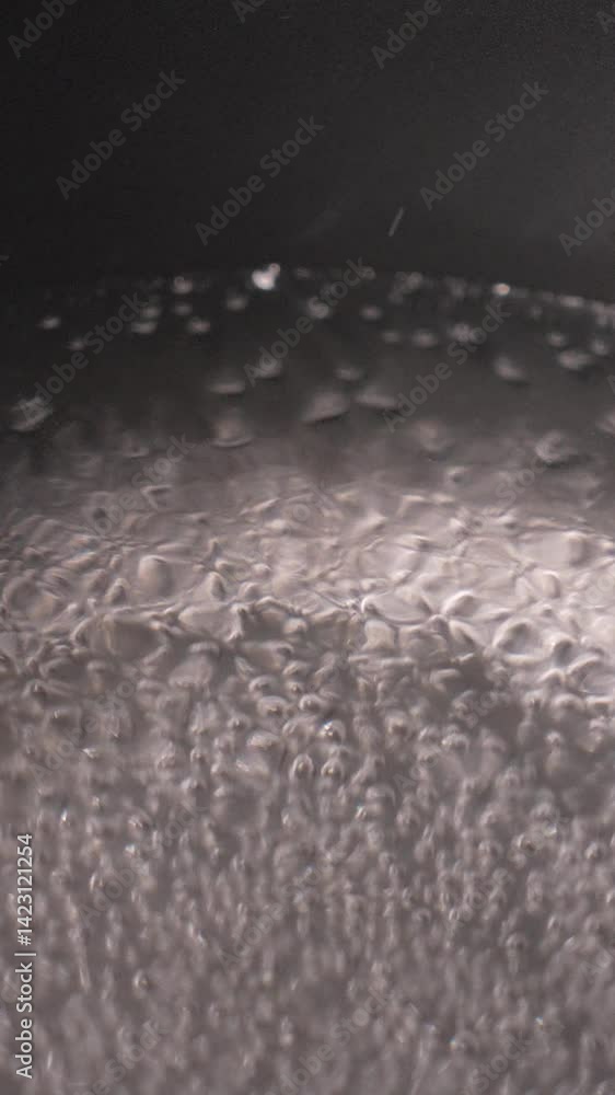 Poster a blurry image of water boiling. the droplets are scattered and overlapping, creating a sense of mov