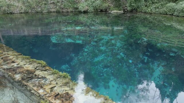 Drone footage of Stifone and the Morica spring in Umbria, Italy: turquoise waters, lush nature, stone ruins, and peaceful river views in a hidden, historic valley.