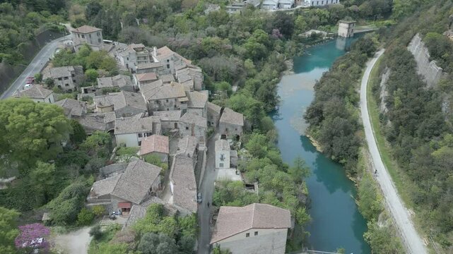 Drone footage of Stifone and the Morica spring in Umbria, Italy: turquoise waters, lush nature, stone ruins, and peaceful river views in a hidden, historic valley.