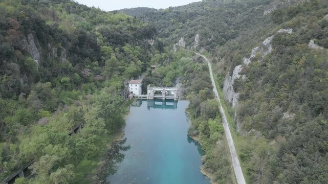 Drone footage of Stifone and the Morica spring in Umbria, Italy: turquoise waters, lush nature, stone ruins, and peaceful river views in a hidden, historic valley.