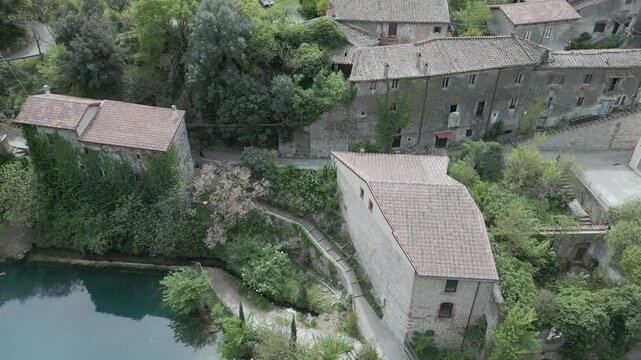 Drone footage of Stifone and the Morica spring in Umbria, Italy: turquoise waters, lush nature, stone ruins, and peaceful river views in a hidden, historic valley.