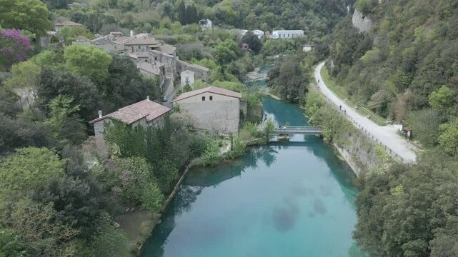 Drone footage of Stifone and the Morica spring in Umbria, Italy: turquoise waters, lush nature, stone ruins, and peaceful river views in a hidden, historic valley.