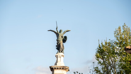 Bronze statue of Archangel Michael atop Castel Sant’Angelo in Rome, holding a sword and shield, symbolizing divine protection and historical defense of the Eternal City