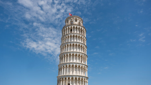 Iconic views of the Leaning Tower of Pisa under clear blue skies, showcasing the architectural elegance and historic charm of this famous Italian landmark in Tuscany