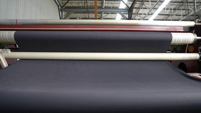 textile lamination machines in action, where layers of thermal insulation and water-resistant coatings are applied to fabrics.