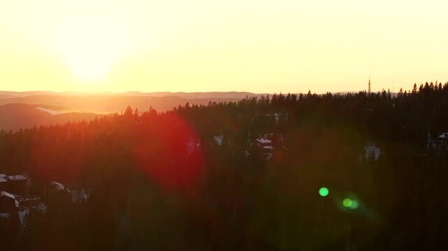 Holmenkollen ski jump forest golden hour sun rays article circle sunset inlet Oslofjord Oslo Norway Norge aerial drone Norwegian coastline Hoved&oslash;ya Hovedoya cross country ski trails upwards motion