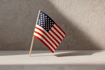 Small United States Flag Displayed on White Surface with Soft Natural Light