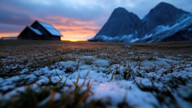Rustic alpine hut at dawn, snow-covered meadow