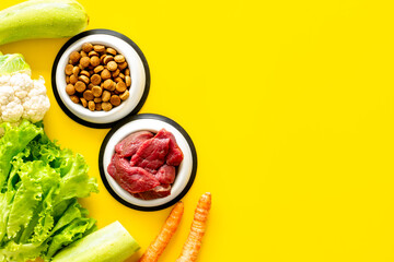Bowls with healthy pet food and ingredients, top view