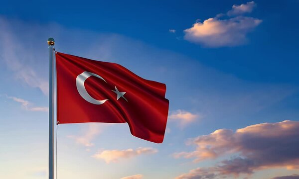Turkish flag waving against a vibrant sunset sky.