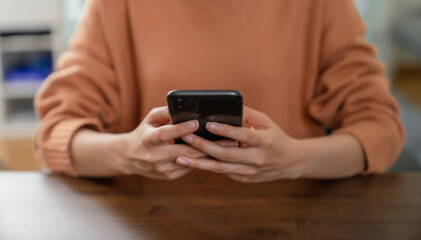 Hand holding smartphone with using social media.