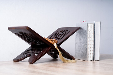 Islam Holy Book Of Muslims, The holy Quran With Tasbih On Wooden Stand Over White Background