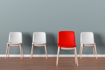 Obraz premium Red chair standing out from other white chairs in waiting room
