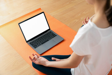 Woman doing exercise yoga plank and blank screen on laptop, for putting advertising to promote.