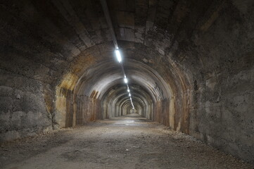 Obraz premium Inside Rijeka tunnel, in city center, built during Wordl War II, to protect civilians from aerial bombings.Anti bombing tunnel made in Rijeka made during the war. Hot and humid atmosphere in a tunnel.