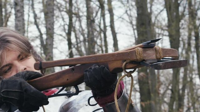 Warrior aims lethal medieval crossbow with deadly quarrel arrowhead