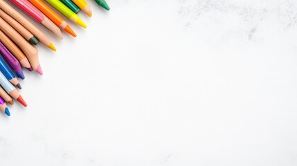 Colorful pencils arranged in a corner on a marble surface