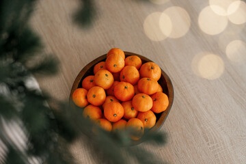 Fresh tangerines in a plate on a table with lights 