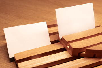 White blank business card mockup with wooden decoration on wooden background