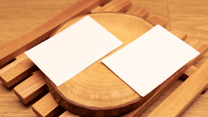 White blank business card mockup with wooden decoration on wooden background