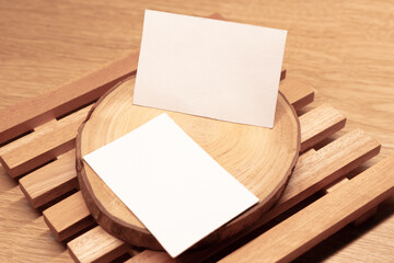White blank business card mockup with wooden decoration on wooden background