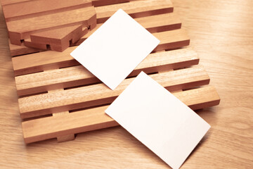White blank business card mockup with wooden decoration on wooden background