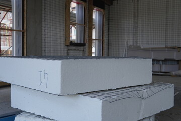 Polystyrene panels combined with wire mesh. Modern house under construction with polystyrene insulation. Insulation materials. Materials for wall insulation. Welded wire reinforcement