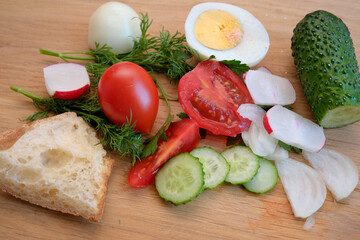 Salad ingredients on a wooden board