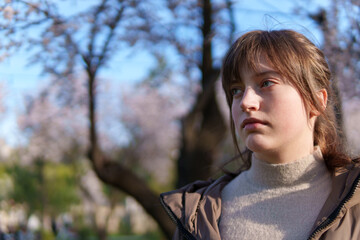 portrait of a teenage girl in a spring park