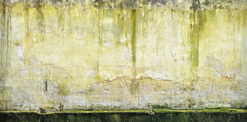 Fototapeta premium textured wall with rough, weathered surface featuring shades of yellow and green, showcasing signs of aging and decay, creating abstract and grunge aesthetic