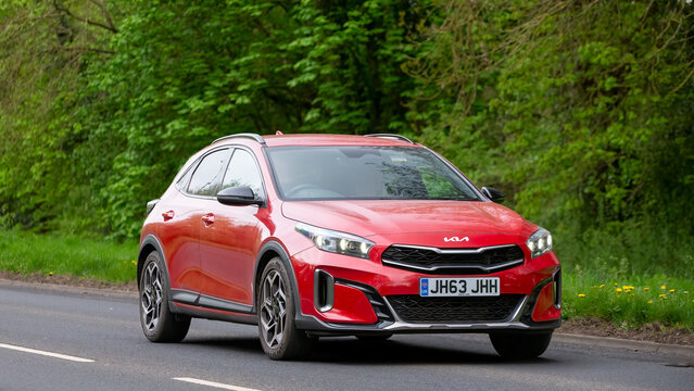 Milton Keynes,UK - Apr. 9th 2025:  2024 red Kia Xceed gt line  car driving on a British country road
