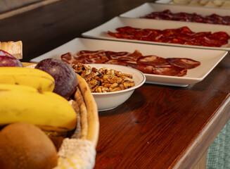 Fresh organic fruit for breakfast with nuts and sausages in a spanish hotel