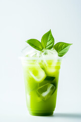 Refreshing green beverage with ice and mint leaves in a clear cup. Perfect for hot summer days.