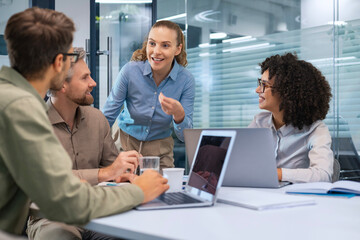 Business team discussing together business plans in office.