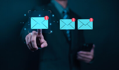 Businessman touching email on virtual screen. New email notification concept for business email communication. Internet technology. Mailbox receives electronic message notification.