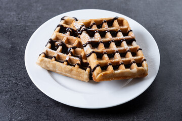 Belgian Waffles with chocolate on black slate background