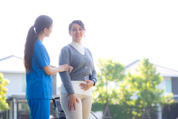 Young caucasian nurse comforting with patient while standing in outdoor park, doctor woman support...