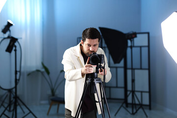 Man with professional video camera in studio