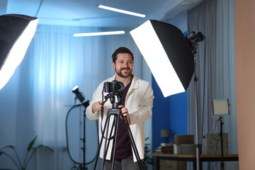 Man with professional video camera in studio