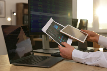 Stock exchange. Man working at desk in office, closeup