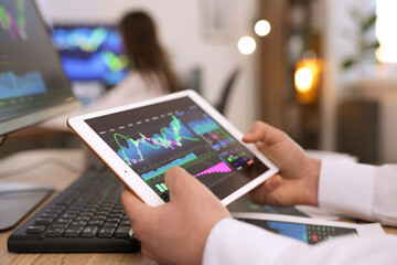 Stock exchange. Man working at desk in office, closeup