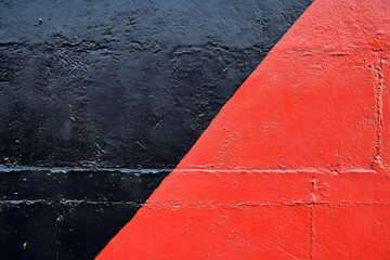 Bold Geometric Shapes in Contrasting Colors on an Urban Wall Create an Eye-Catching Mural in the Afternoon Light