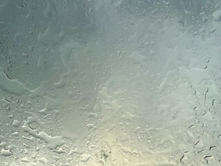 Rain falling through the glass, The sight of rain from the sky, Rain falling through clear glass.