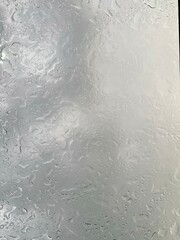 Rain falling through the glass, The sight of rain from the sky, Rain falling through clear glass.