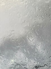 Rain falling through the glass, The sight of rain from the sky, Rain falling through clear glass.