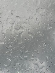 Rain falling through the glass, The sight of rain from the sky, Rain falling through clear glass.